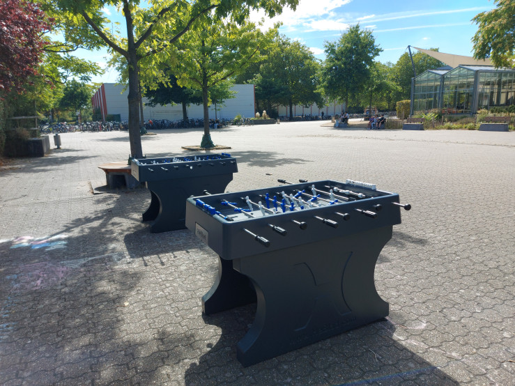 Twee voetbaltafels op schoolplein
